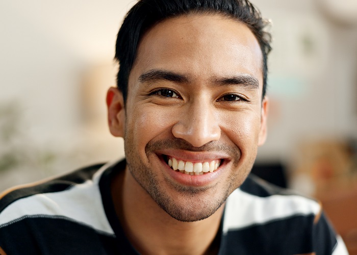 Asian American man with nice smile and white teeth Handsome Asian American man with a beautiful smile and perfect teeth