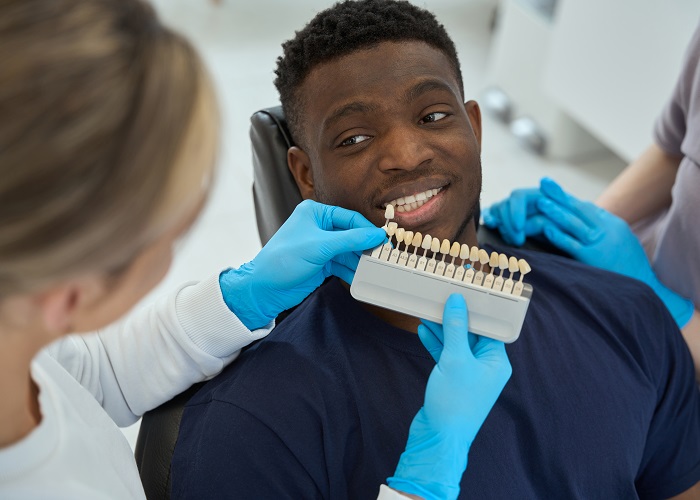 Nurse chooses veneers for male in the clinic Nurse chooses veneers for male in the clinic